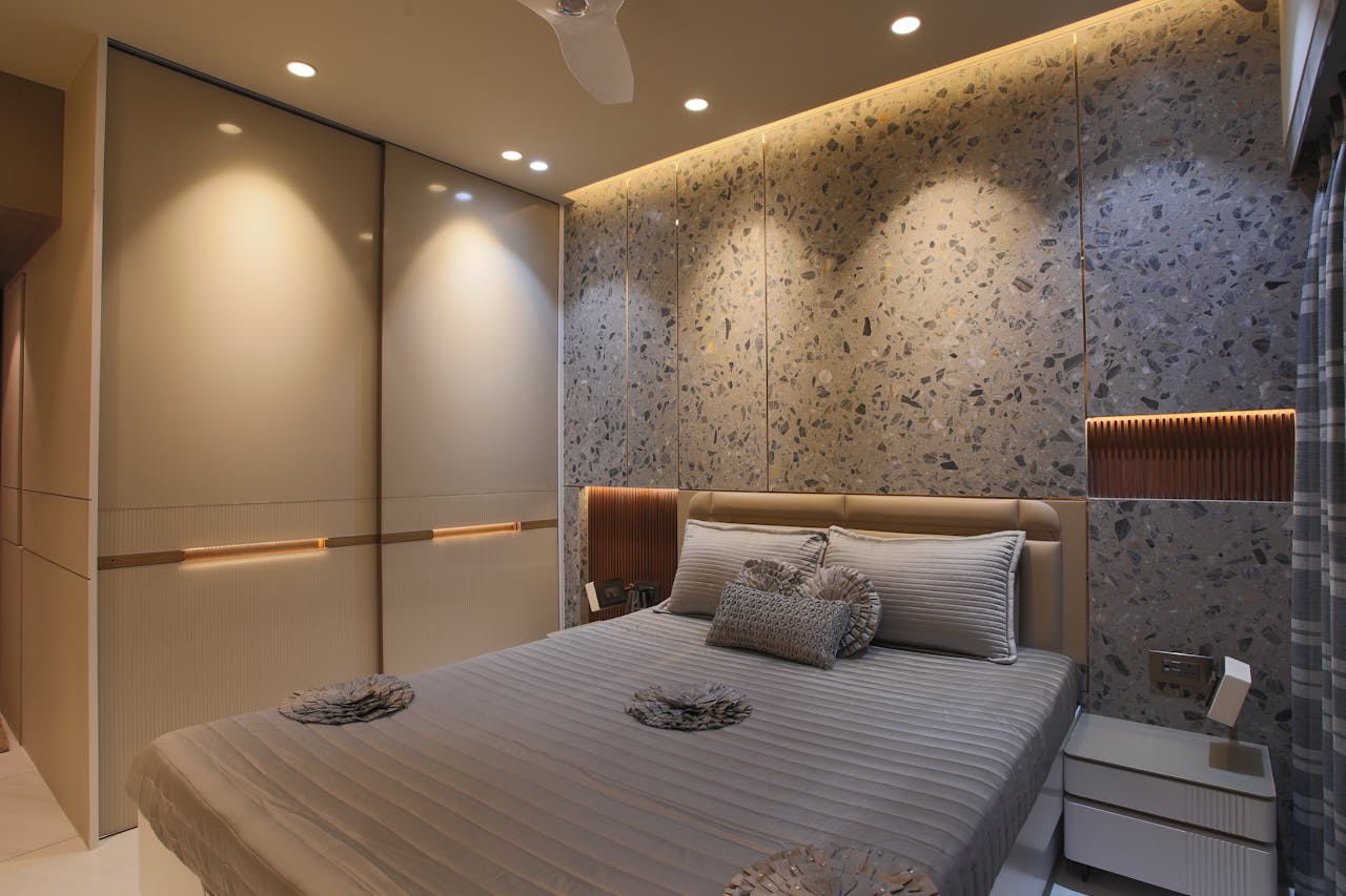 A chic modern bedroom featuring a stylish contemporary design with ambient lighting and sleek furniture.
